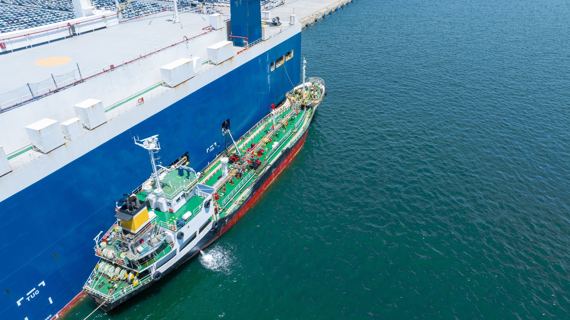 Oil ship refueling to Cargo ship at dock, Refueling at sea Oil products ship fuelling a large Bulk carrier